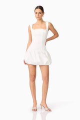 Brunette model wearing Ingrid Bubble Mini Dress in White posed shot