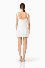 Brunette model wearing Ingrid Bubble Mini Dress in White back shot