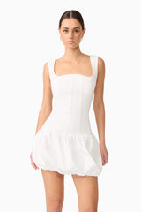 Brunette model wearing Ingrid Bubble Mini Dress in White close up shot