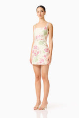 Brunette model wearing the Greta Embroidered Mini Dress in Cream & Pink Floral side shot