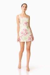 Brunette model wearing the Greta Embroidered Mini Dress in Cream & Pink Floral posed shot