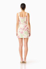 Brunette model wearing the Greta Embroidered Mini Dress in Cream & Pink Floral back shot