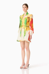 Brunette model wearing the Lilia Long Sleeve Mini Dress in Multi Floral side shot 