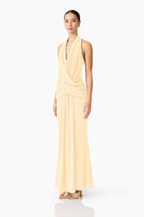 Brunette model wearing the 
Simone Cowl Neck Gown in Butter Yellow side shot