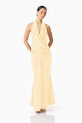 Brunette model wearing the 
Simone Cowl Neck Gown in Butter Yellow posed shot