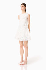 Brunette model wearing the Giovanna Shift Mini Dress in White side shot
