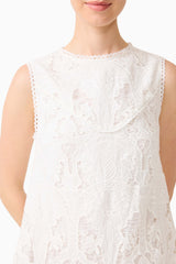 Brunette model wearing the Giovanna Shift Mini Dress in White detail shot