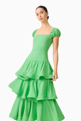 Brunette model wearing the Emilie Tiered Maxi Dress in Kelly Green close up shot