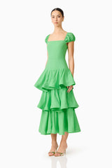 Brunette model wearing the Emilie Tiered Maxi Dress in Kelly Green side shot
