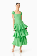 Brunette model wearing the Emilie Tiered Maxi Dress in Kelly Green posed shot