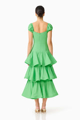 Brunette model wearing the Emilie Tiered Maxi Dress in Kelly Green back shot