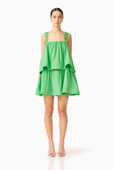 Brunette model wearing the Emilie Tiered mini Dress in Kelly Green front shot