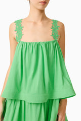 Brunette model wearing the Emilie Tiered mini Dress in Kelly Green detail shot