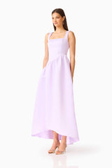 Brunette model wearing the Ruelle A-Line Maxi Dress in Purple side shot 