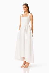 Brunette model wearing the Ruelle A-Line Maxi Dress in Pearl White side shot 