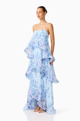 Brunette model wearing the Tilly Tiered Maxi Dress in Blue Floral side shot