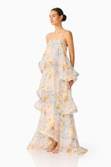 Brunette model wearing the Tilly Tiered Maxi Dress in Yellow Floral side shot