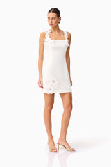 Brunette model wearing Chantelle Floral Mini Dress in White looking away shot