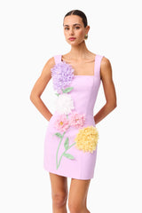 Brunette model wearing Buttercup Embroidered Party Mini Dress Purple close up shot 