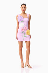 Brunette model wearing Buttercup Embroidered Party Mini Dress Purple posed shot 