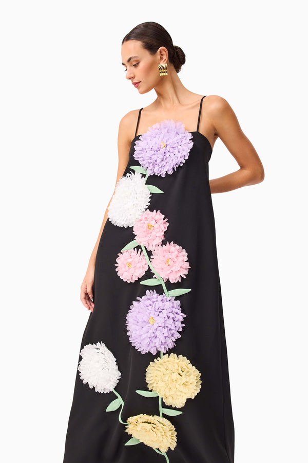 Brunette model wearing Buttercup Embroidered Maxi Dress in Black close up shot