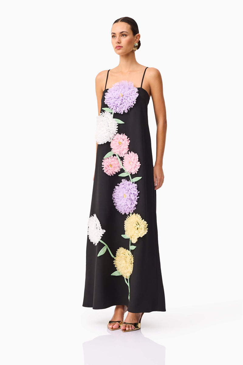 Brunette model wearing Buttercup Embroidered Maxi Dress in Black side shot