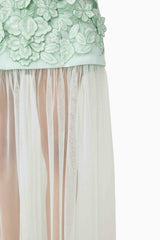 Brunette model wearing the Roseate Floral Maxi Dress in Mint Green skirt detail shot 