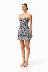 Brunette model wearing Roseate Floral Mini Dress in Black side shot