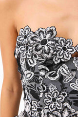 Brunette model wearing Roseate Floral Mini Dress in Black detail shot