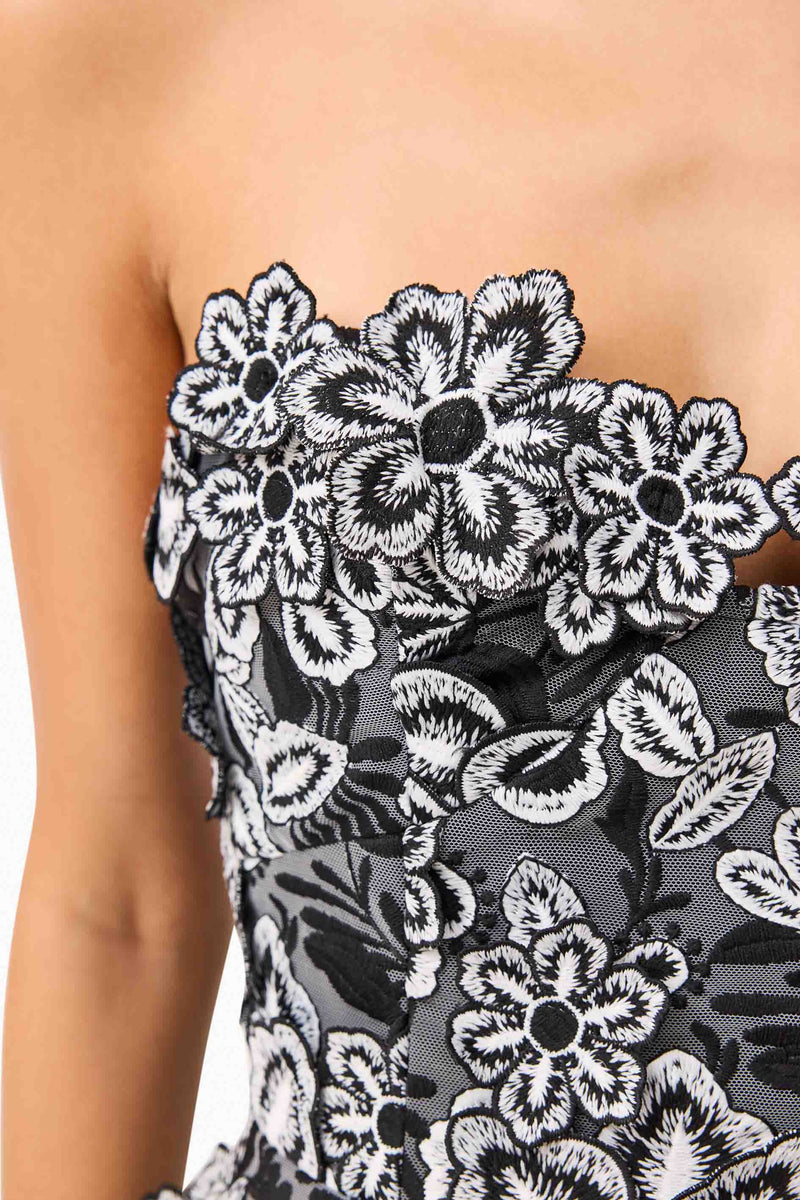 Brunette model wearing Roseate Floral Mini Dress in Black detail shot