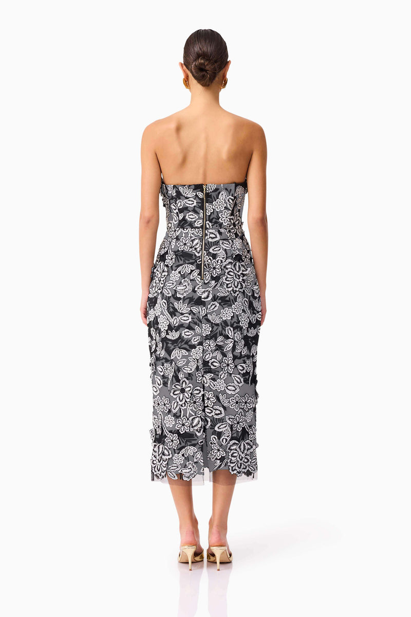 Brunette model wearing Roseate Strapless Midi Dress in Black back shot