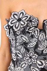 Brunette model wearing Roseate Strapless Midi Dress in Black detail shot