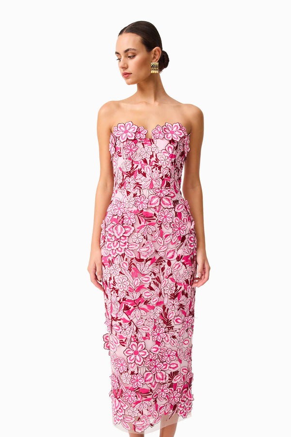 Brunette model wearing Roseate Strapless Midi Dress in Pink close up looking away shot