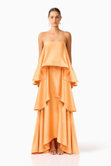 Brunette model wearing the Tilly Tiered Maxi Dress in Orange front shot