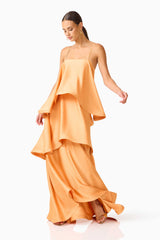 Brunette model wearing the Tilly Tiered Maxi Dress in Orange posed twirling shot
