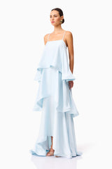 Brunette model wearing Tilly Tiered Maxi Dress in Blue side shot