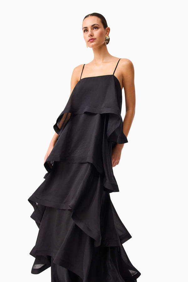 Brunette model wearing Tilly 5 Tiered Maxi Dress in Black close up looking away shot