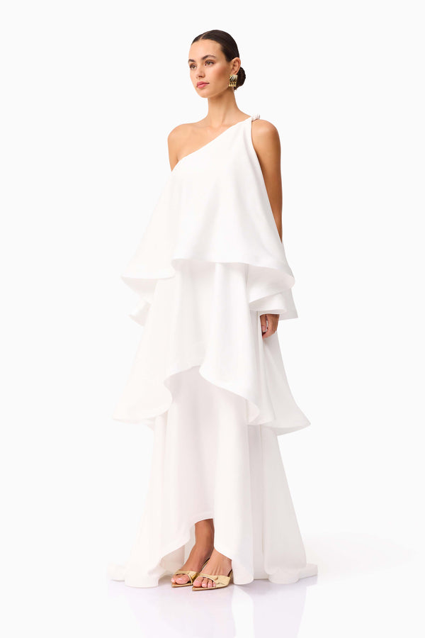 Brunette model wearing Tilly One Shoulder Maxi Dress in White side shot