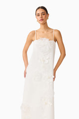 Gemma Floral Maxi Dress in White with floral appliques & relaxed fit close up shot with hands on hips