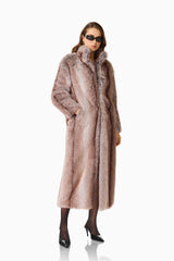 Kinley Faux Fur Coat in Brown with collared neckline and long sleeves posed side shot hand on in pocked  shot