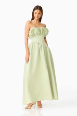 Brunette model wearing the Laurel Sleeveless Maxi Dress in Sage Green posed leaning shot 