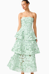 Brunette model wearing the Roseate Tiered Maxi Dress in Mint Green close up shot
