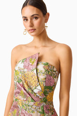 Brunette model wearing the Patricia Strapless Mini Dress in Gold & Purple Floral detail shot