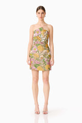 Brunette model wearing the Patricia Strapless Mini Dress in Gold & Purple Floral front shot