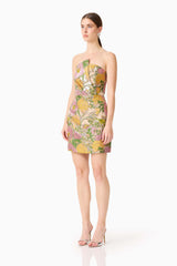 Brunette model wearing the Patricia Strapless Mini Dress in Gold & Purple Floral side shot