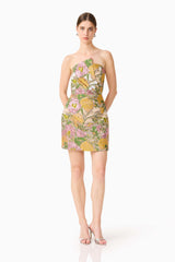 Brunette model wearing the Patricia Strapless Mini Dress in Gold & Purple Floral posed shot