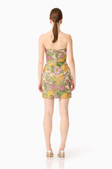 Brunette model wearing the Patricia Strapless Mini Dress in Gold & Purple Floral back shot