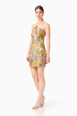 Brunette model wearing the Patricia Strapless Mini Dress in Gold & Purple Floral posed side shot