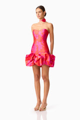 Brunette model wearing Eloise Strapless Mini Dress in Pink & Red side shot