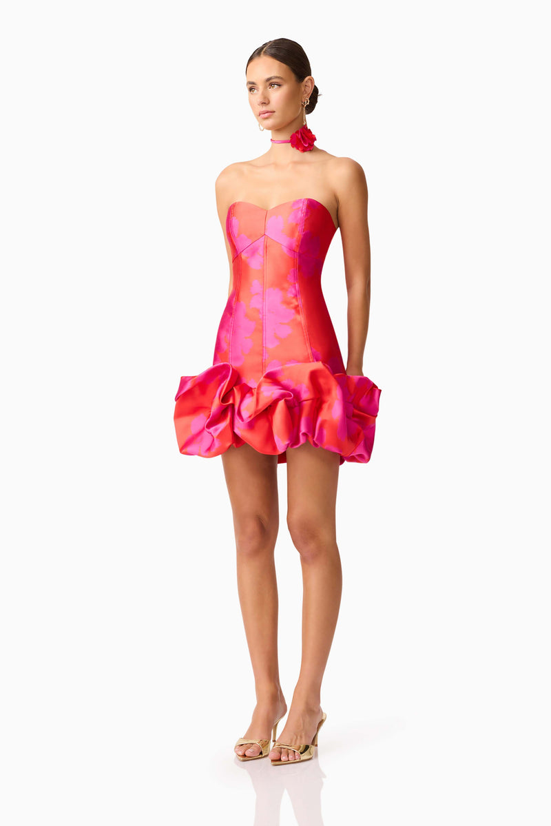 Brunette model wearing Eloise Strapless Mini Dress in Pink & Red side shot